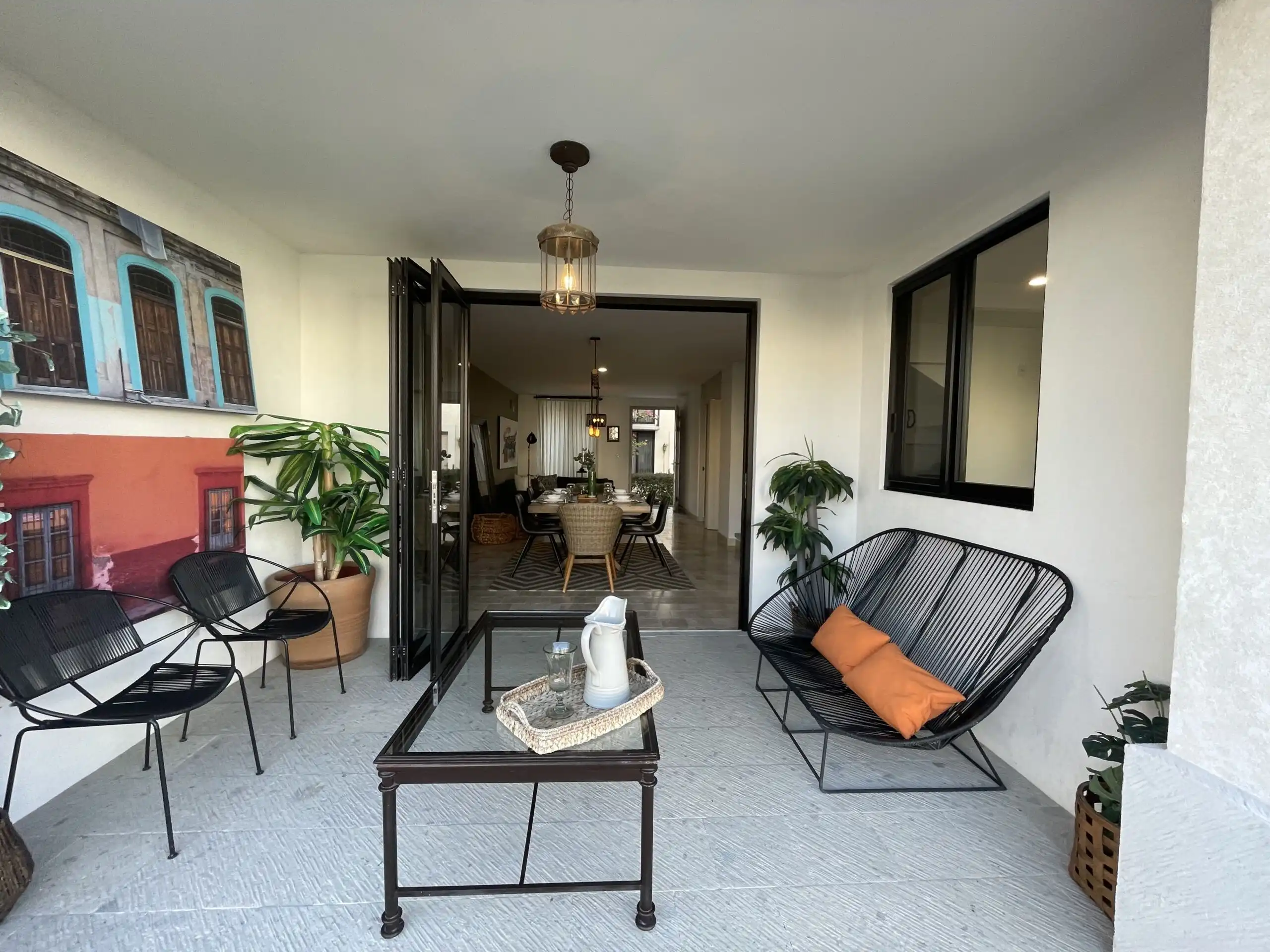 Luxury Home with Heated Pool in La Luminaria Elegant outdoor patio with seating and potted plants at Casa Santa Mónica, a luxury property in San.