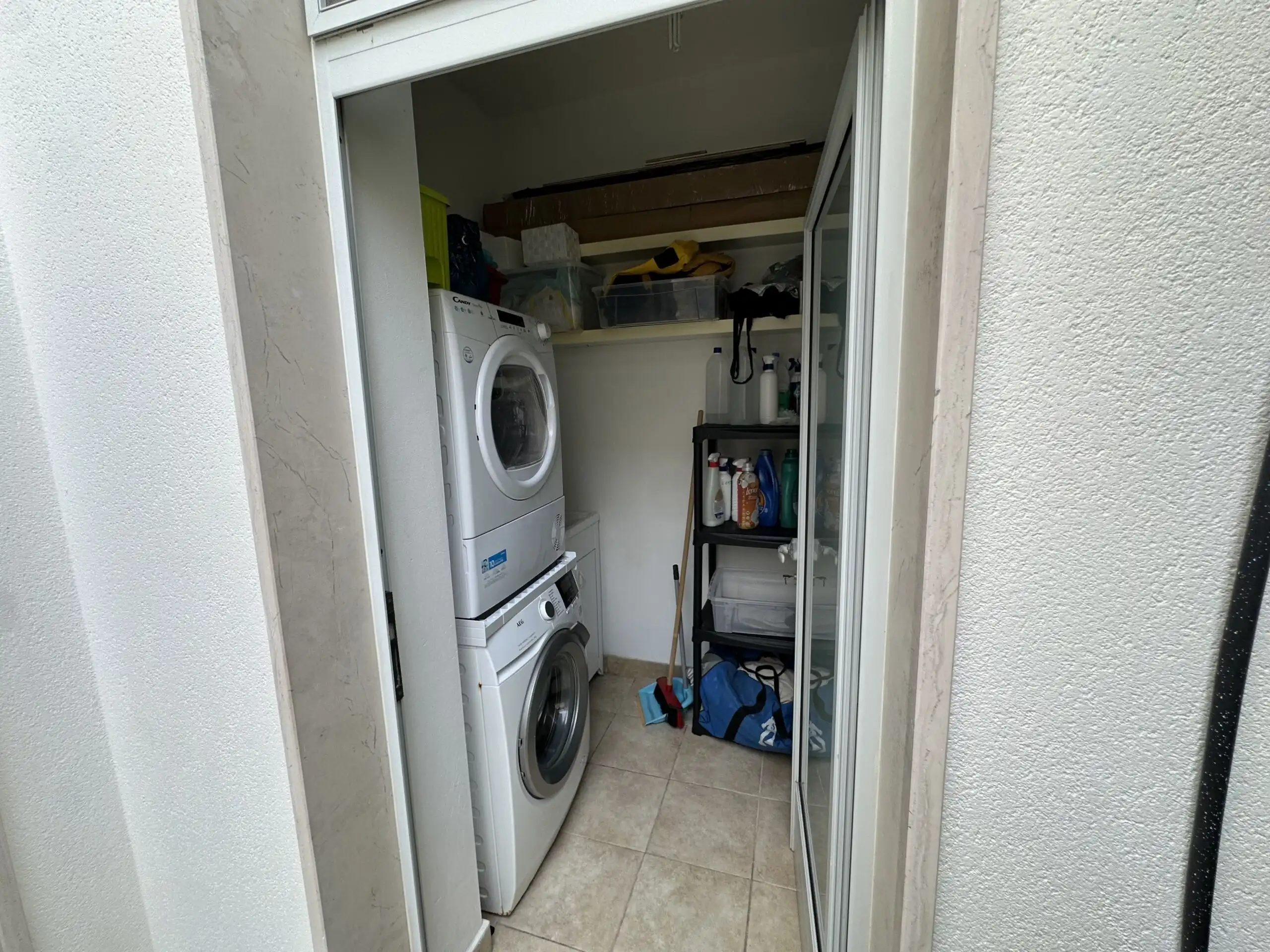 Panoramic villa laundry room with washer and storage in Puglia.