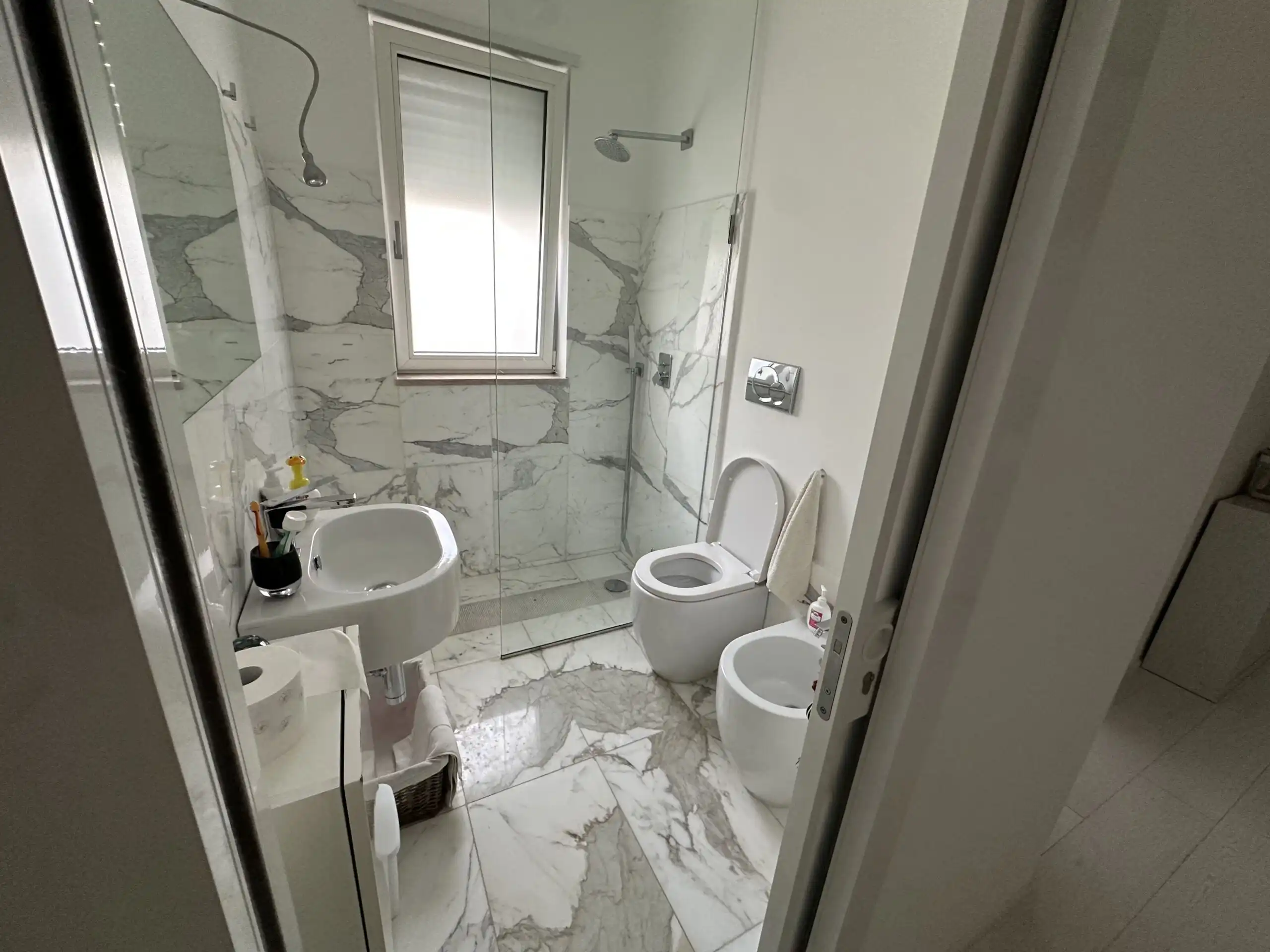 Panoramic bathroom with marble finishes in a luxury villa near Otranto, Puglia.