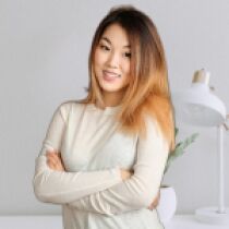 Modern woman smiling in bright office setting.