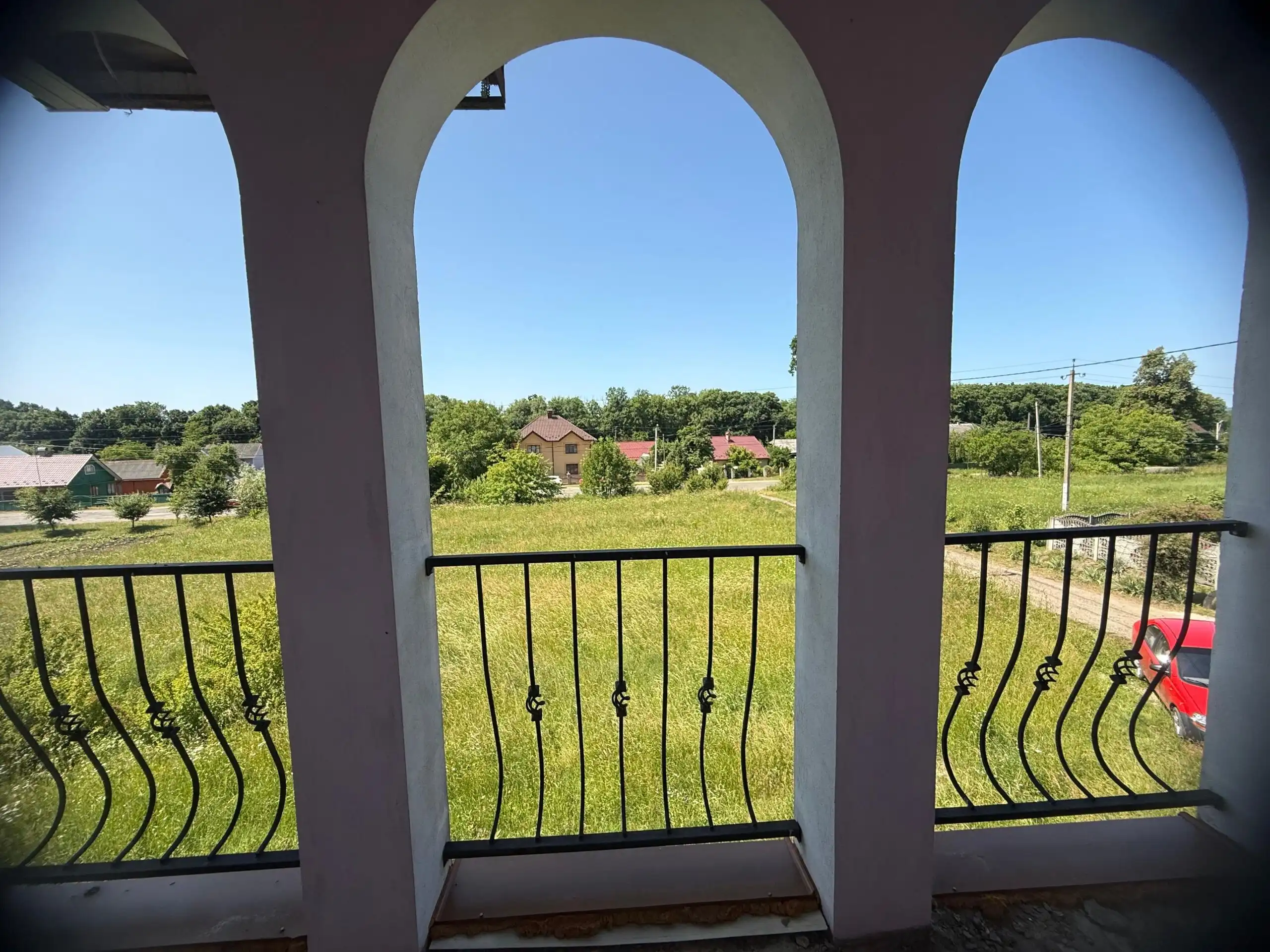 Balcony overlooking lush green fields and scenic landscape in Ukraine. Perfect spot for relaxation a.