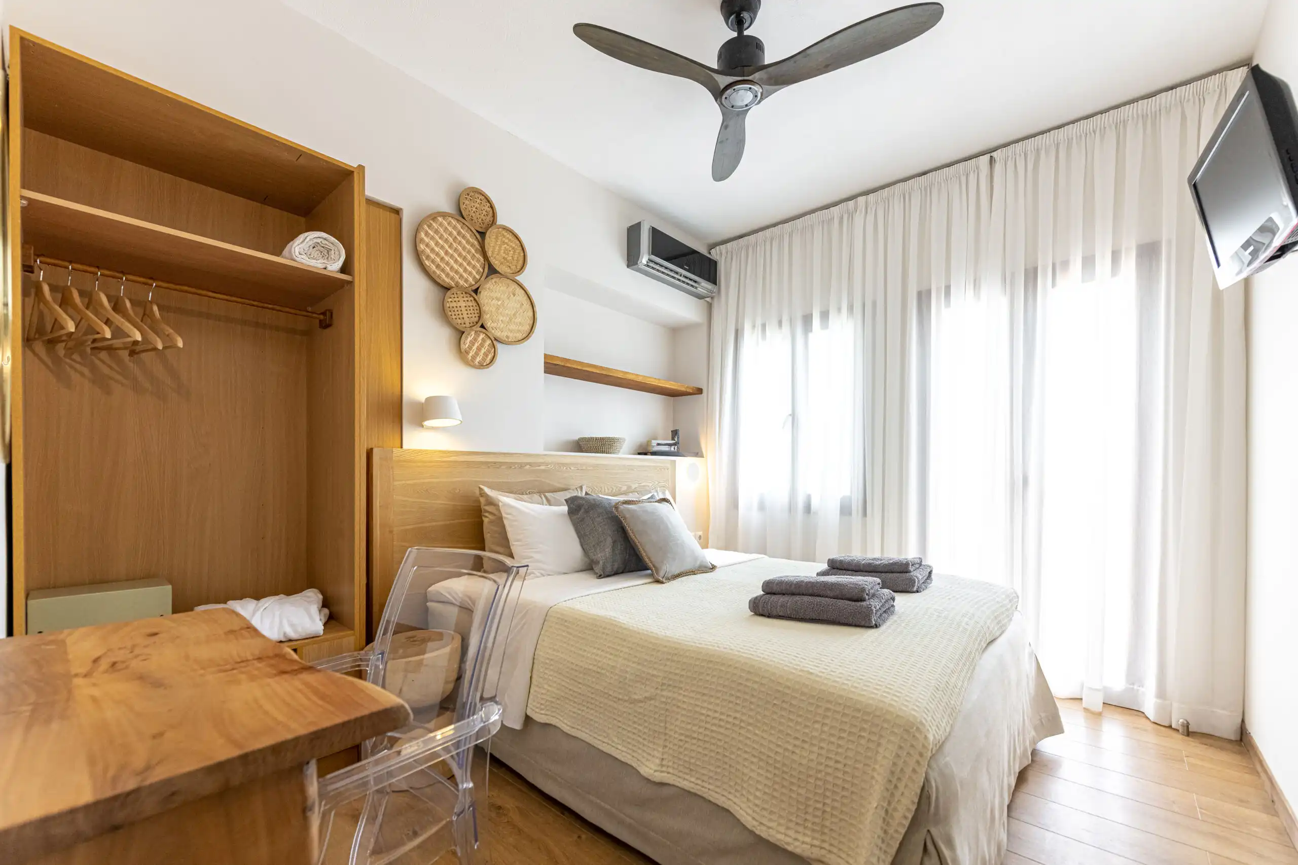 View villa bedroom with modern decor and natural light in Skiathos, Greece.