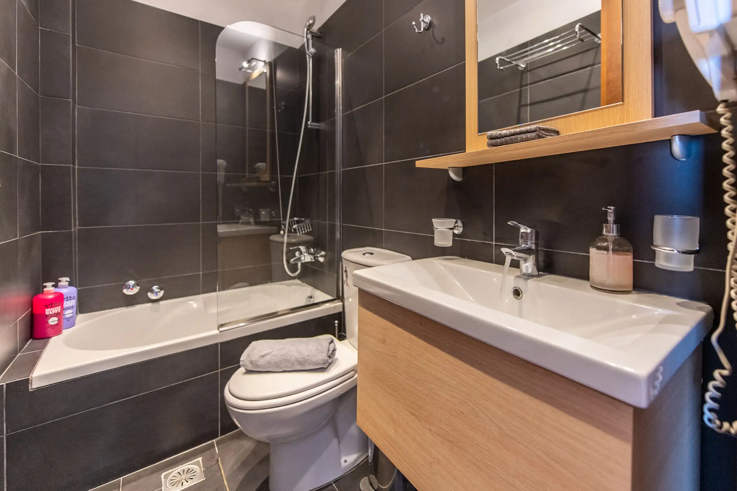 Elegant bathroom with modern fixtures and sea views in Skiathos villa complex.