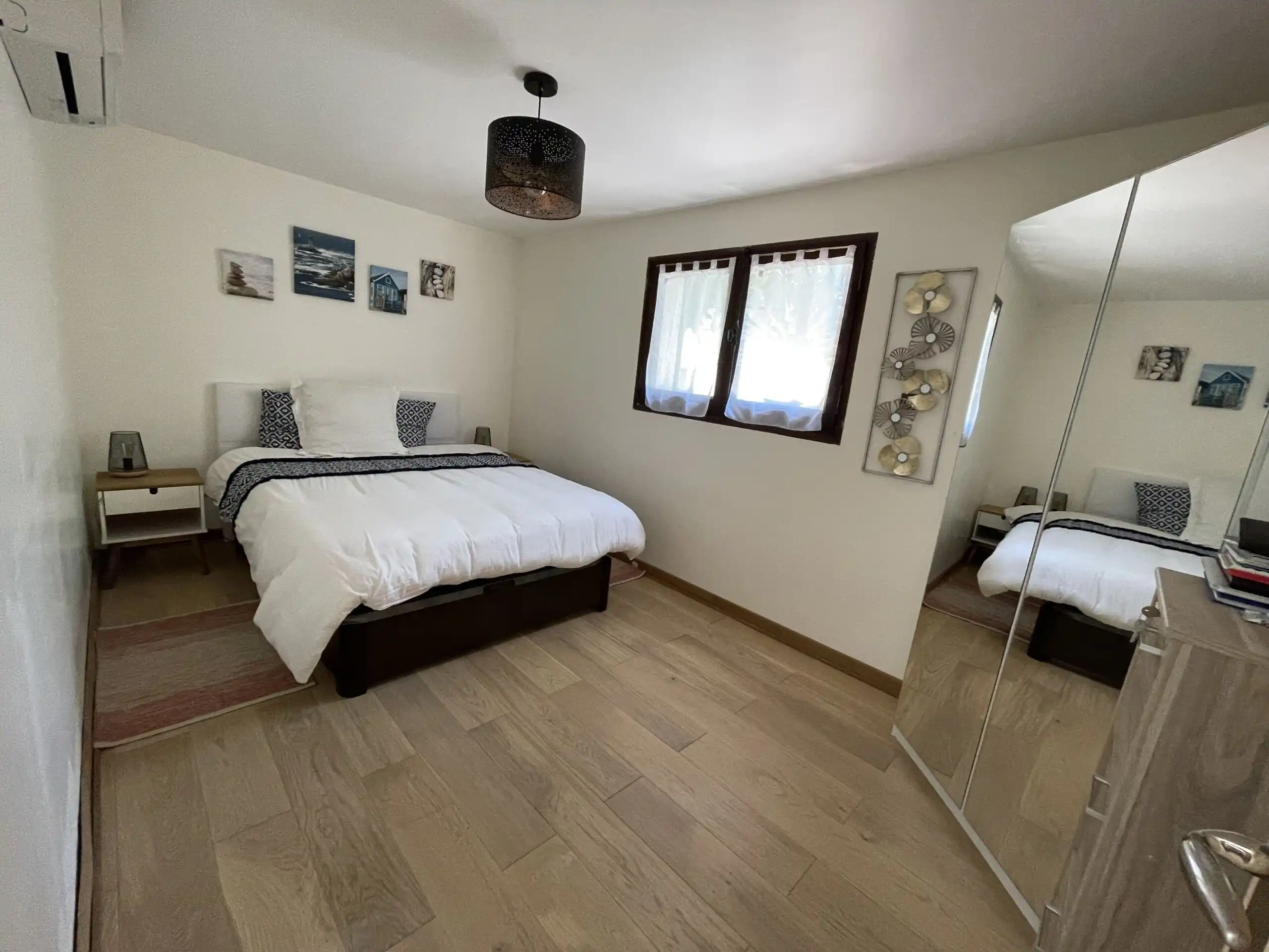 Luxury family villa bedroom with modern decor and large window in Biot, French Riviera.