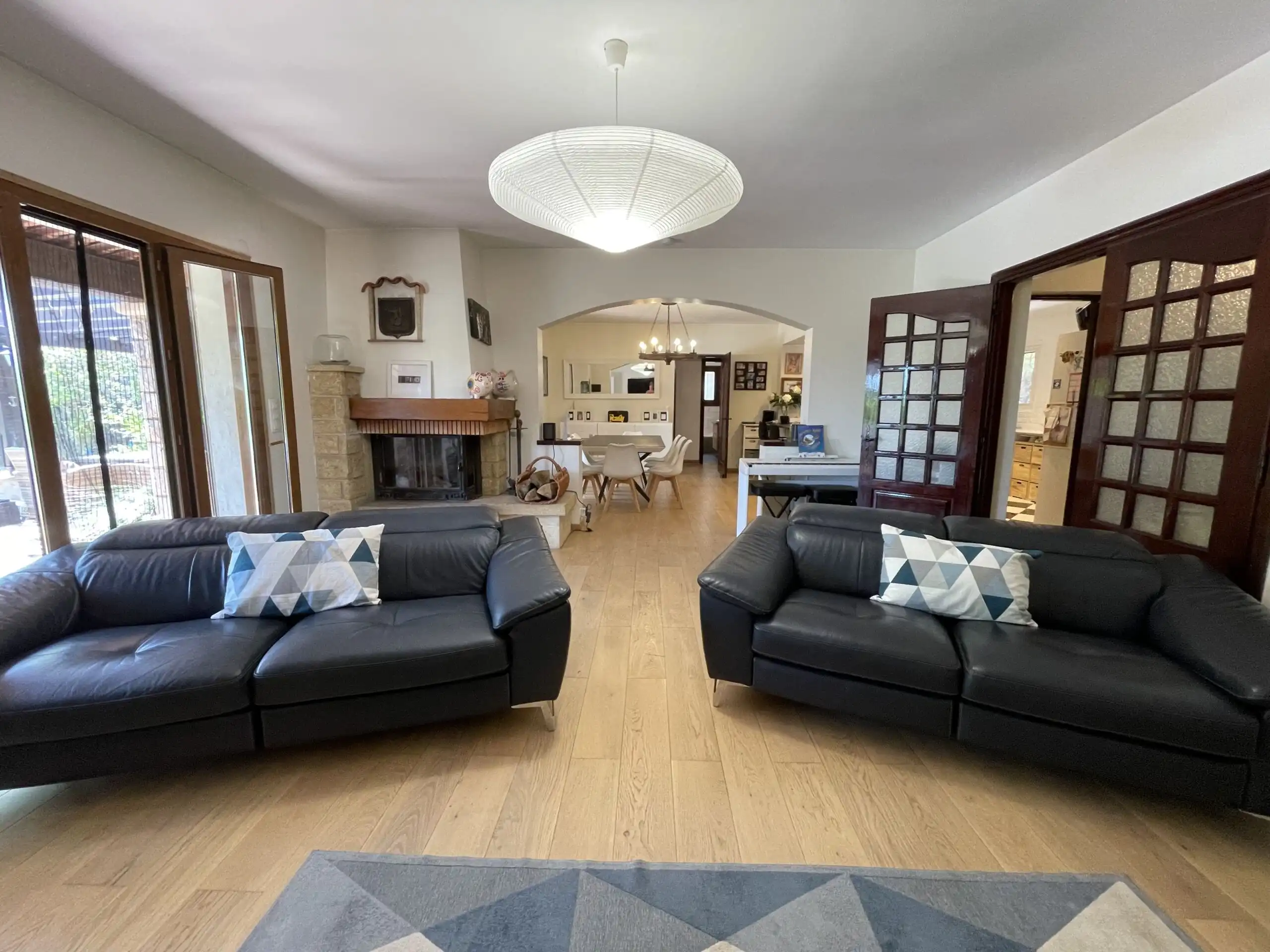 Luxury family villa living room with modern sofas and large windows.