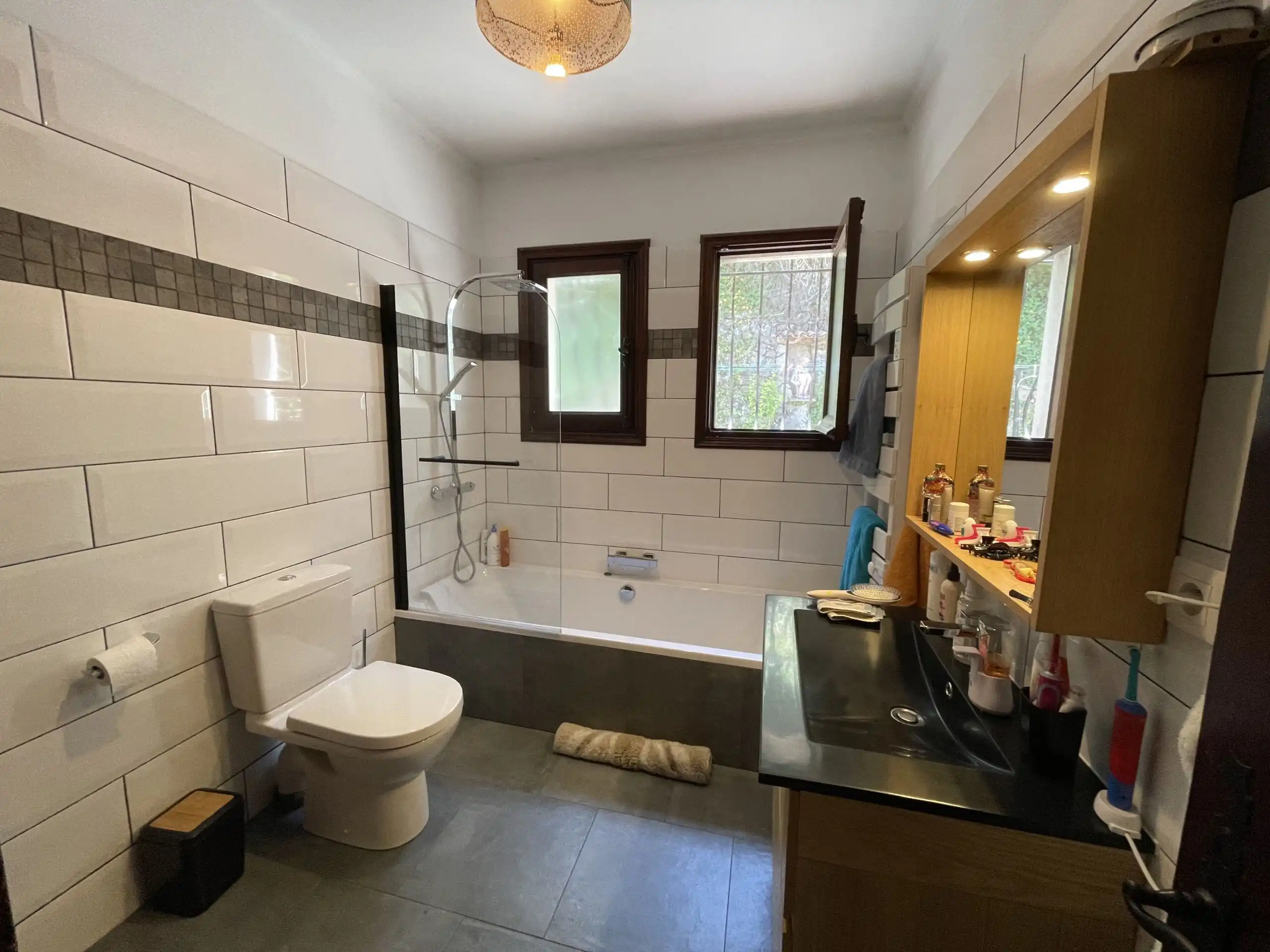 Bright bathroom with bathtub, toilet, and vanity in a renovated villa.