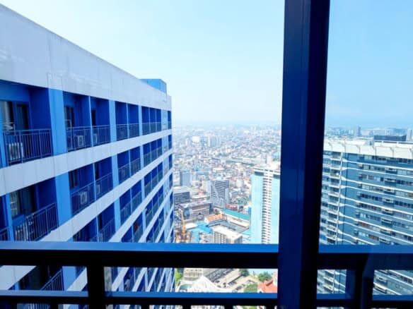 City skyline view from a 1-bedroom apartment in Manila.