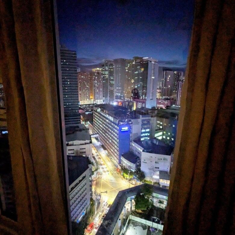 City view from Kroma Tower Manila apartment window at night.