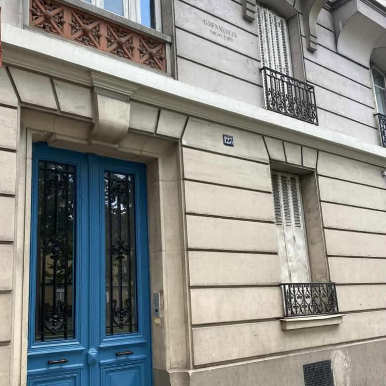 Apartment with blue door and classic Parisian architecture.