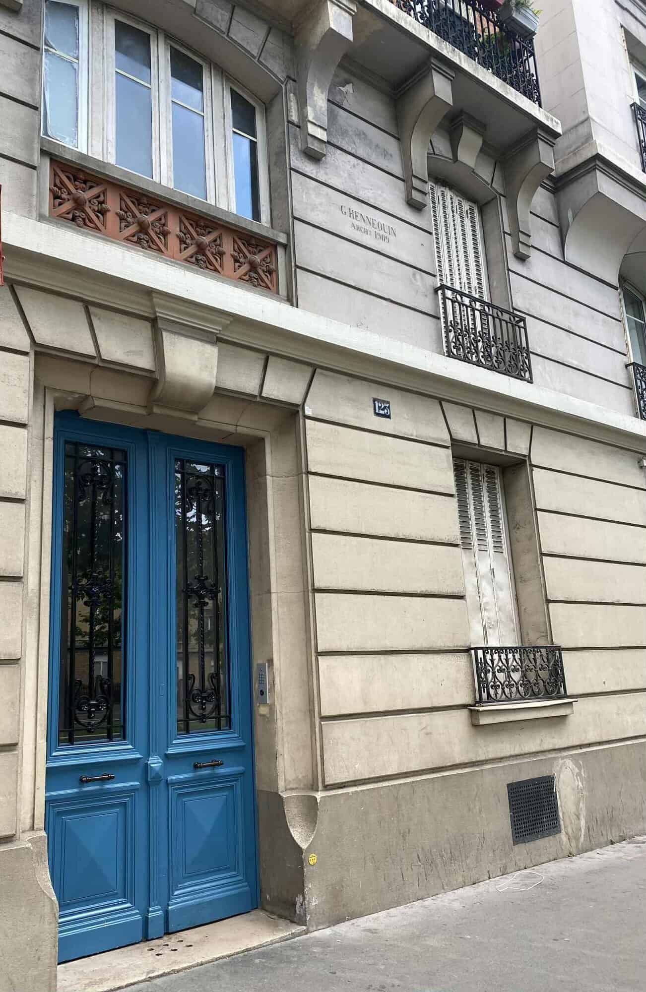 Apartment with blue door and classic Parisian architecture.