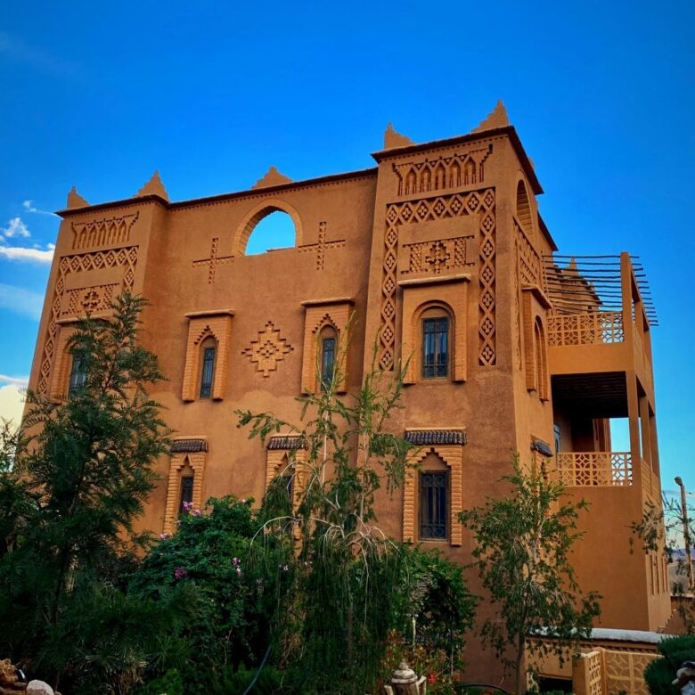 Kasbah Tiziri hotel for sale in Imzough, Morocco, featuring traditional architecture and scenic surr.