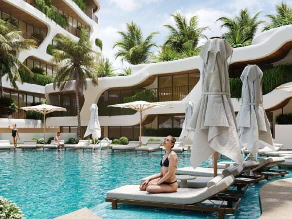 Beautiful pool area at Pandawa Dream Complex Bali with sun loungers and umbrellas. Perfect for relax.