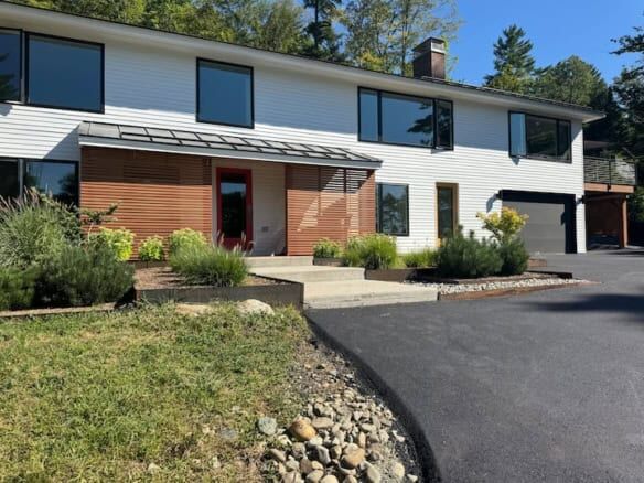 Modern 5-bedroom house for sale in Hanover, New Hampshire with stylish exterior and landscaped yard.