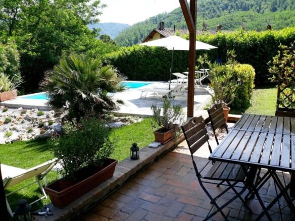 Beautiful outdoor patio with pool and garden in Bagni di Lucca, Italy.