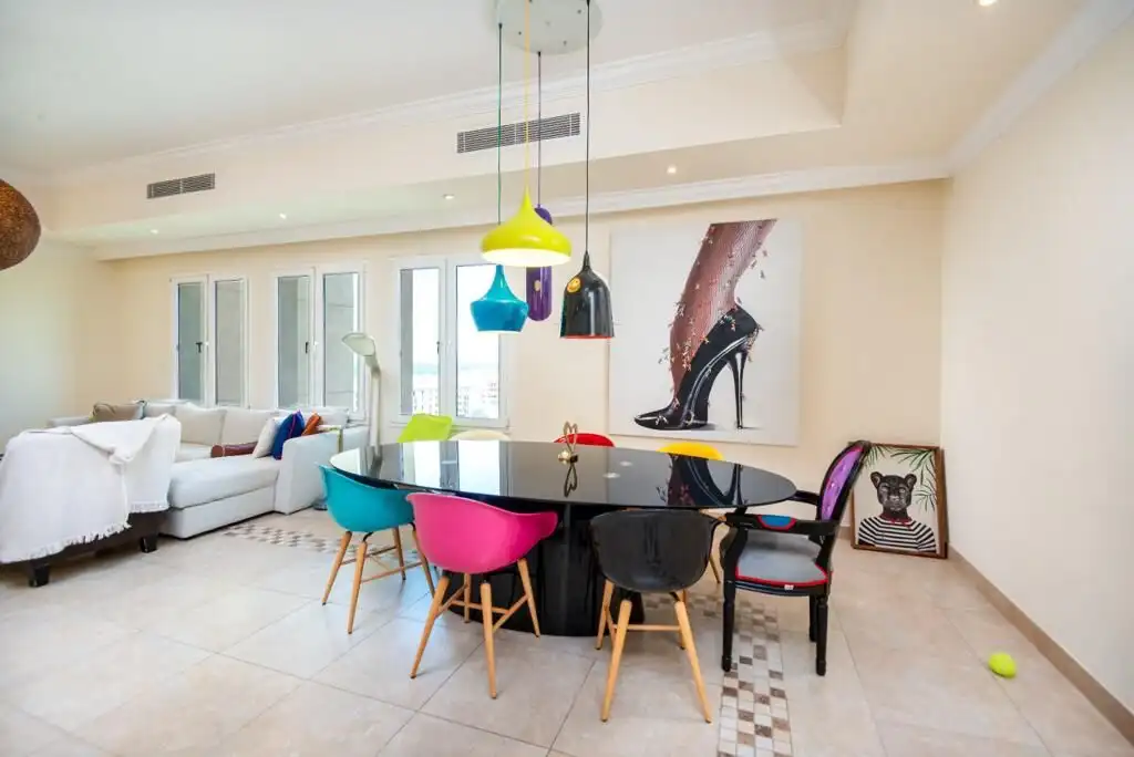 Spacious 3-bedroom apartment featuring a large balcony, vibrant decor, and stunning marina and sea v.