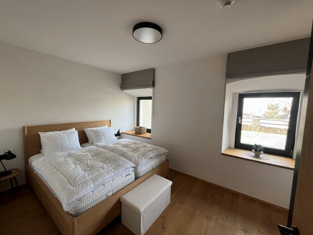 Luxury Rattendorf Apartment Spacious bedroom in a luxury apartment in Rattendorf with modern decor and natural light.