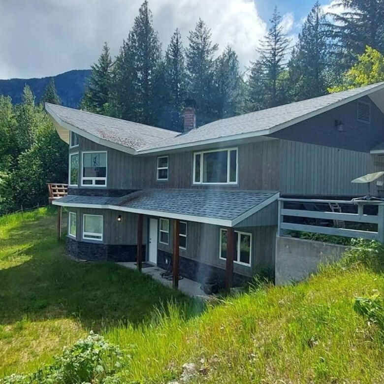 Beautiful 4-bedroom estate for sale in Bella Coola, British Columbia, surrounded by lush greenery an.