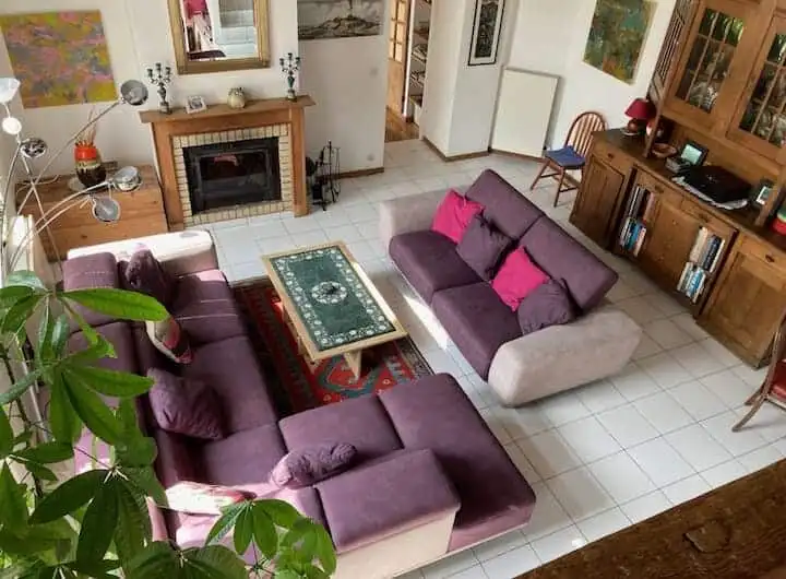 Spacious living room with comfortable sofas, fireplace, and classic decor in a beautiful Sorrus prop.