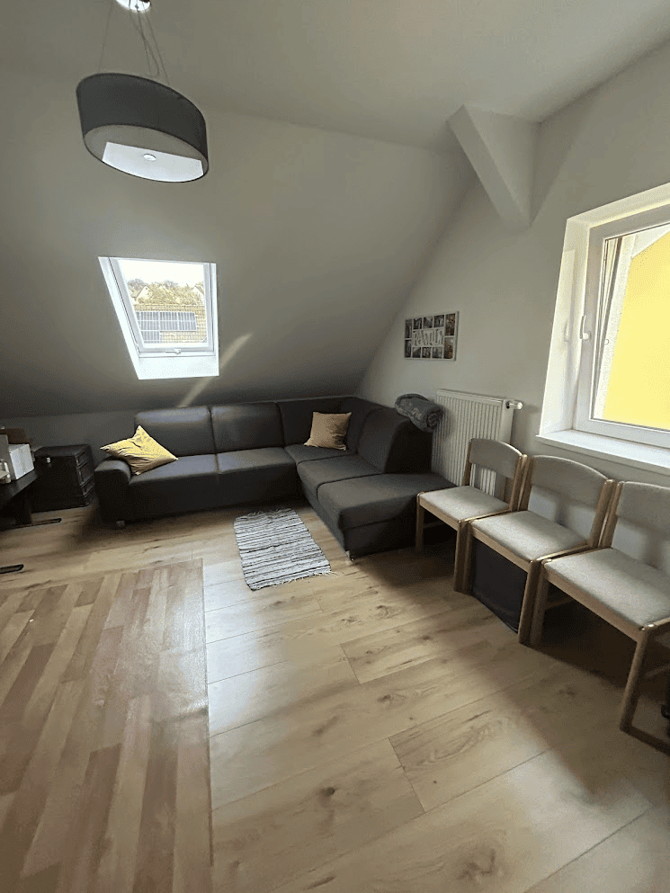 Building with 4 Apartments For Sale in Wilhelmsburg Apartment interior with modern seating and natural light.