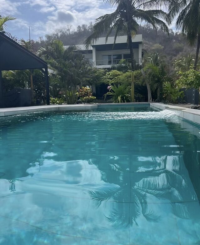 Modern luxury villa with pool, tropical garden, and ocean views in El Matal, Manabí.