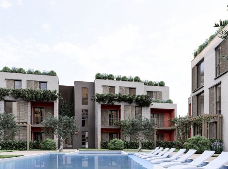 Contemporary apartments at Palm City Residencies in Kotor with lush greenery and scenic views.