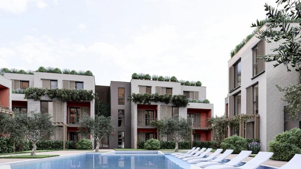 Contemporary apartments at Palm City Residencies in Kotor with lush greenery and scenic views.