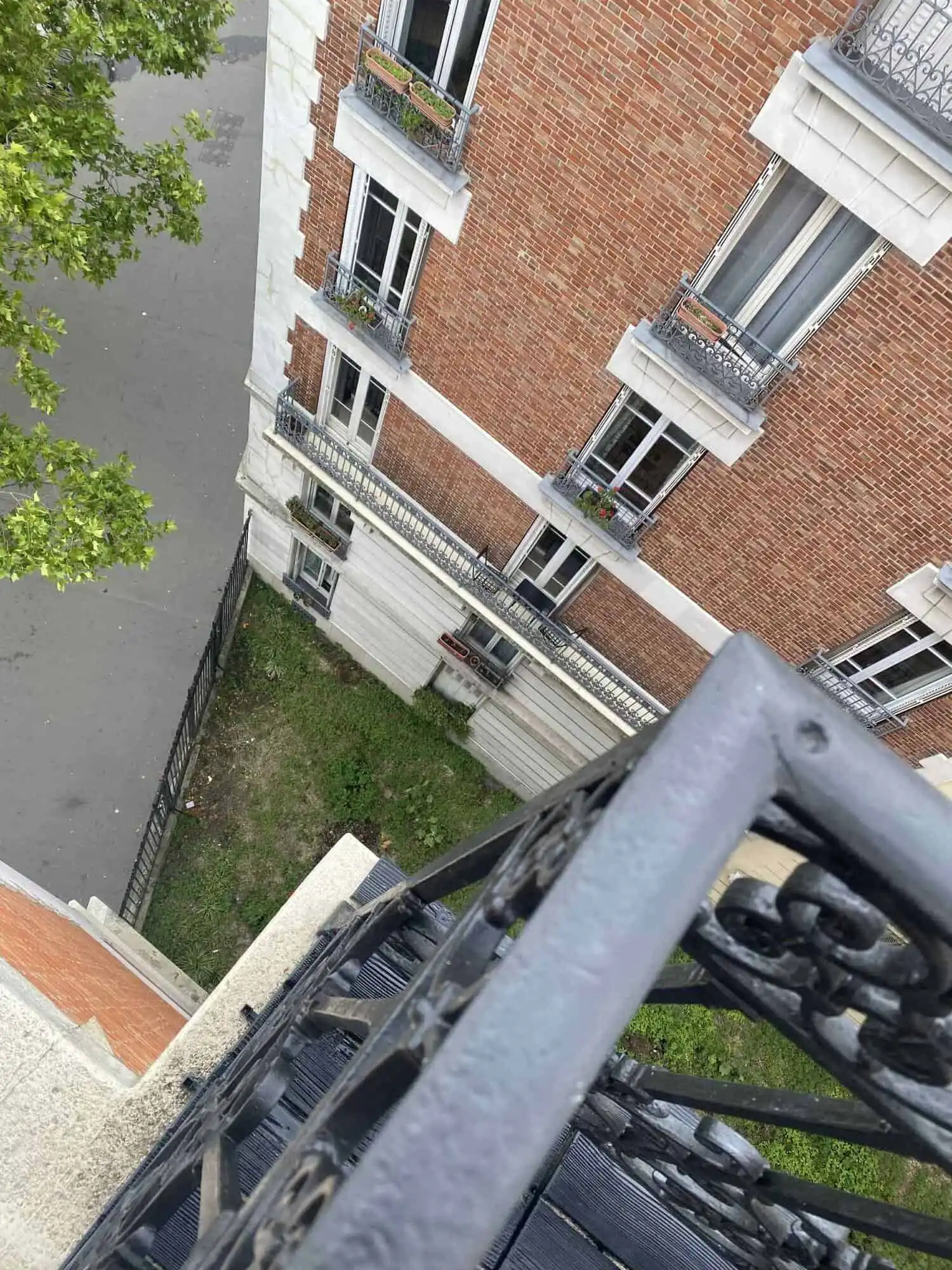 Elegant 1-bedroom apartment view in Paris with classic architecture and balcony details.