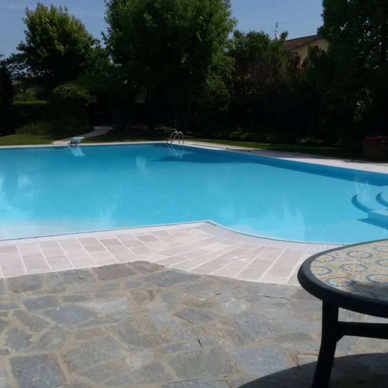 Spacious outdoor pool area at a luxury 8-bedroom estate in Forli, ideal for relaxing and entertainin.