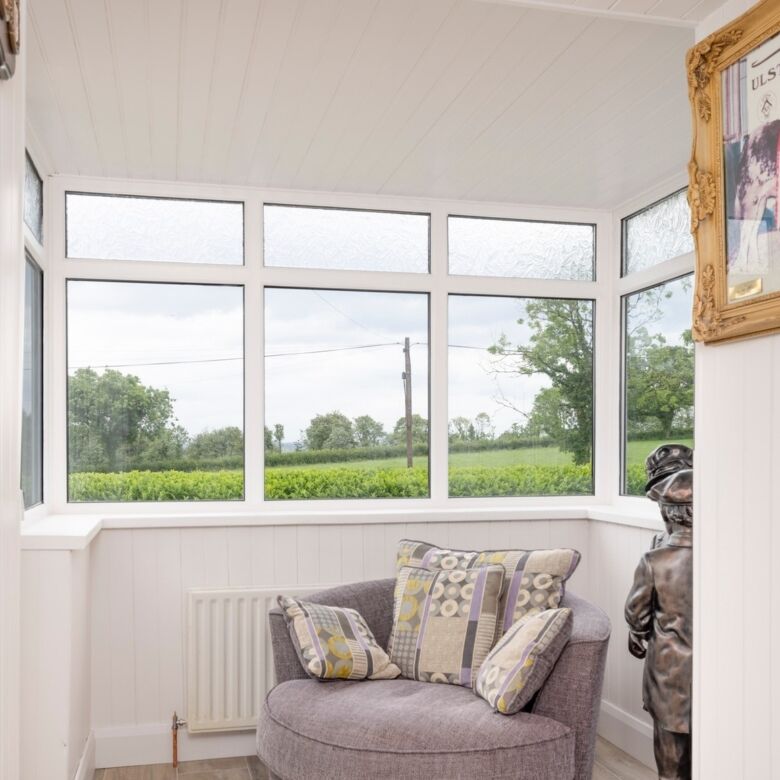 Bright interior with large windows overlooking scenic countryside in Cosbystown, Enniskillen, County.