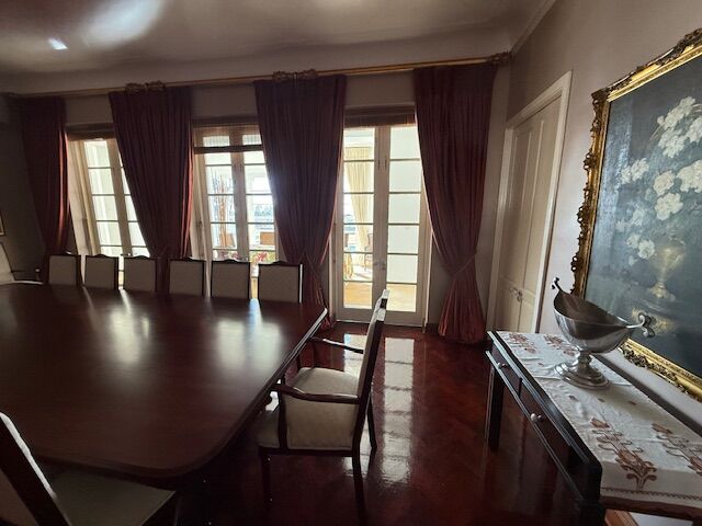 Elegant dining room with large windows and rich curtains in Durban.