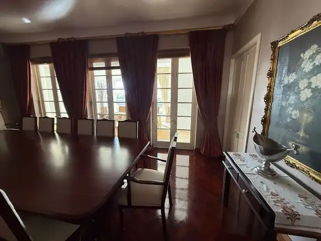 Elegant dining room with large windows and rich curtains in Durban.