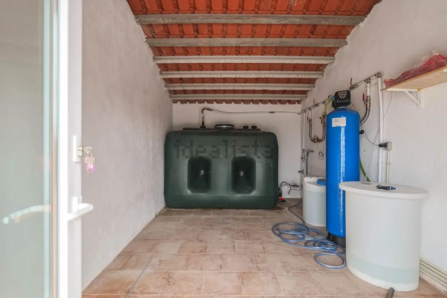 Water filtration and storage system in a spacious utility room.