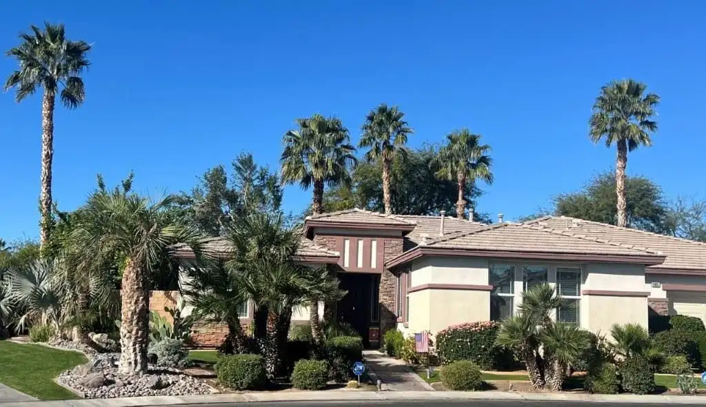 Elegant 4-bedroom villa for sale in Generations Indio, California, featuring lush landscaping and mo.