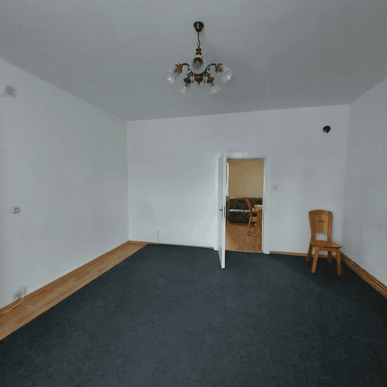 Interior view of a building with 4 apartments in Wilhelmsburg, showing a simple living room.