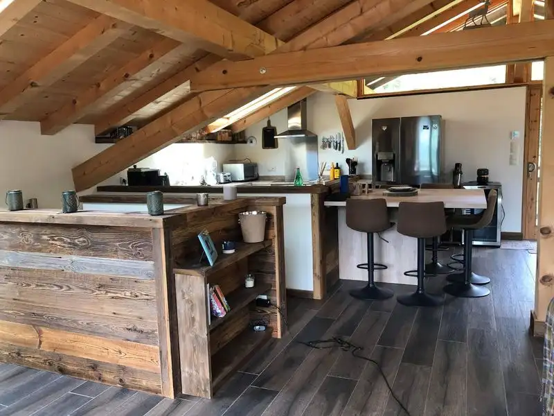 Spacious chalet kitchen with modern appliances and rustic wooden accents in Samoens.