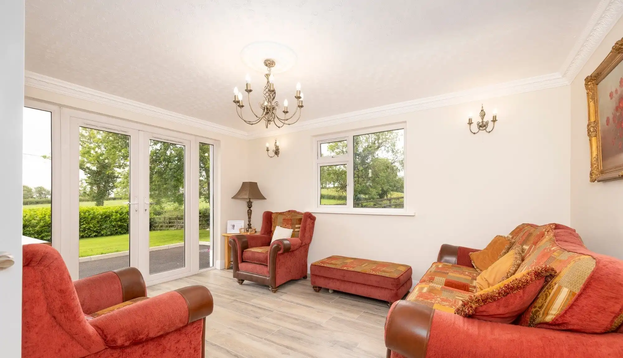 Bright living room featuring large windows overlooking lush greenery in Cosbystown Enniskillen.