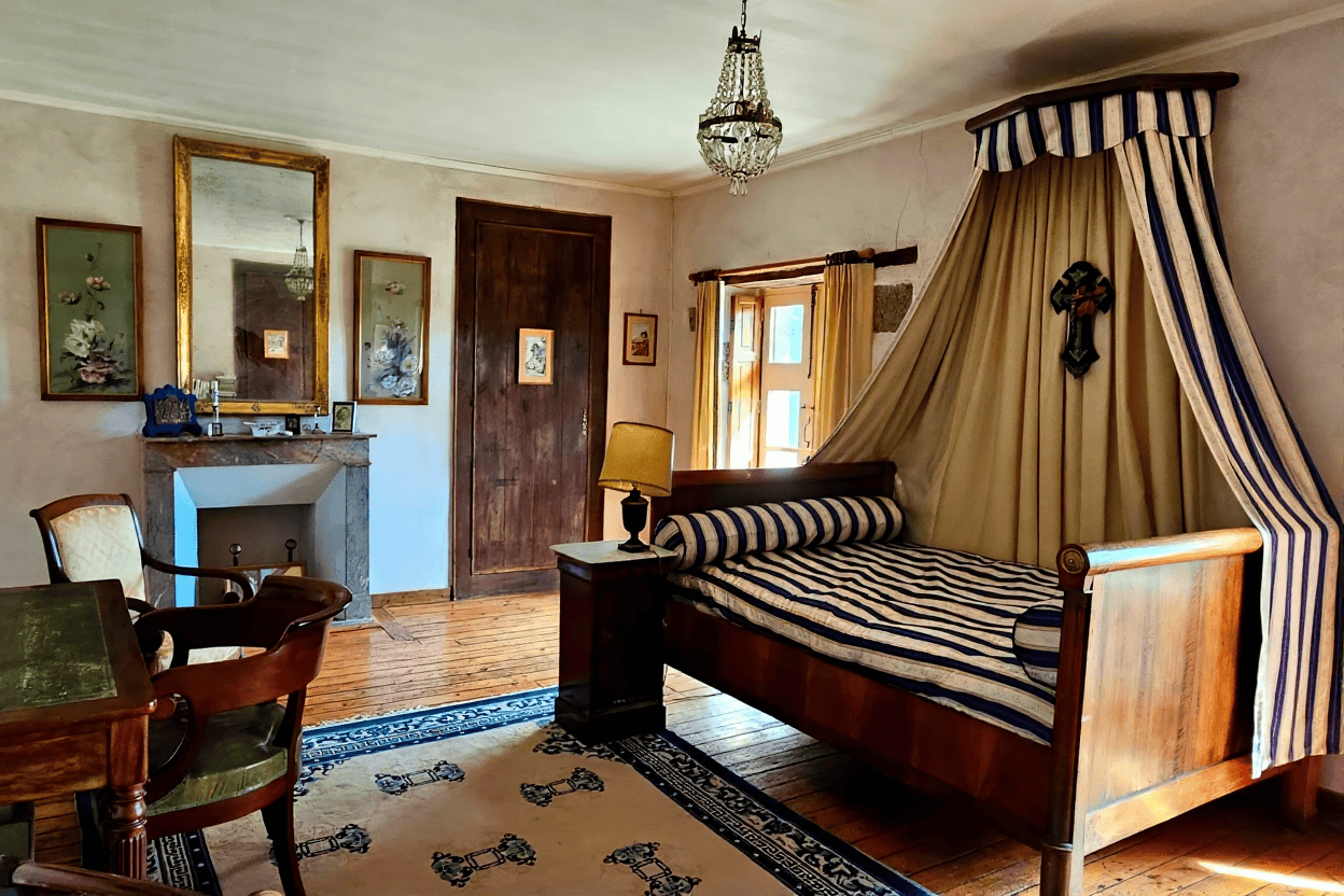Luxury 5 Bed Le Manoir de Dougeru for Sale Elegant bedroom with a canopy bed and vintage decor in Le Manoir de Dougeru.