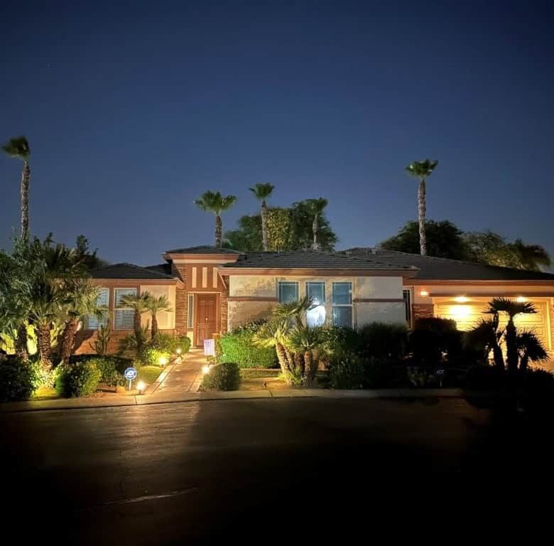 Elegant 4-bedroom villa for sale in Indio, California, featuring modern design and lush landscaping.