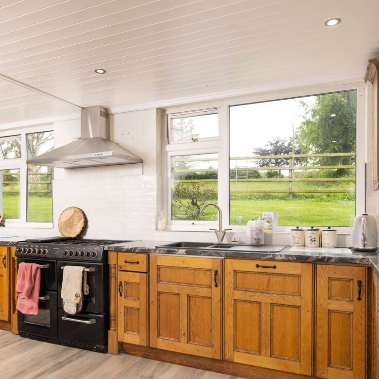 Bright kitchen with wooden cabinets and modern appliances in Cosbystown Enniskillen. Perfect family.
