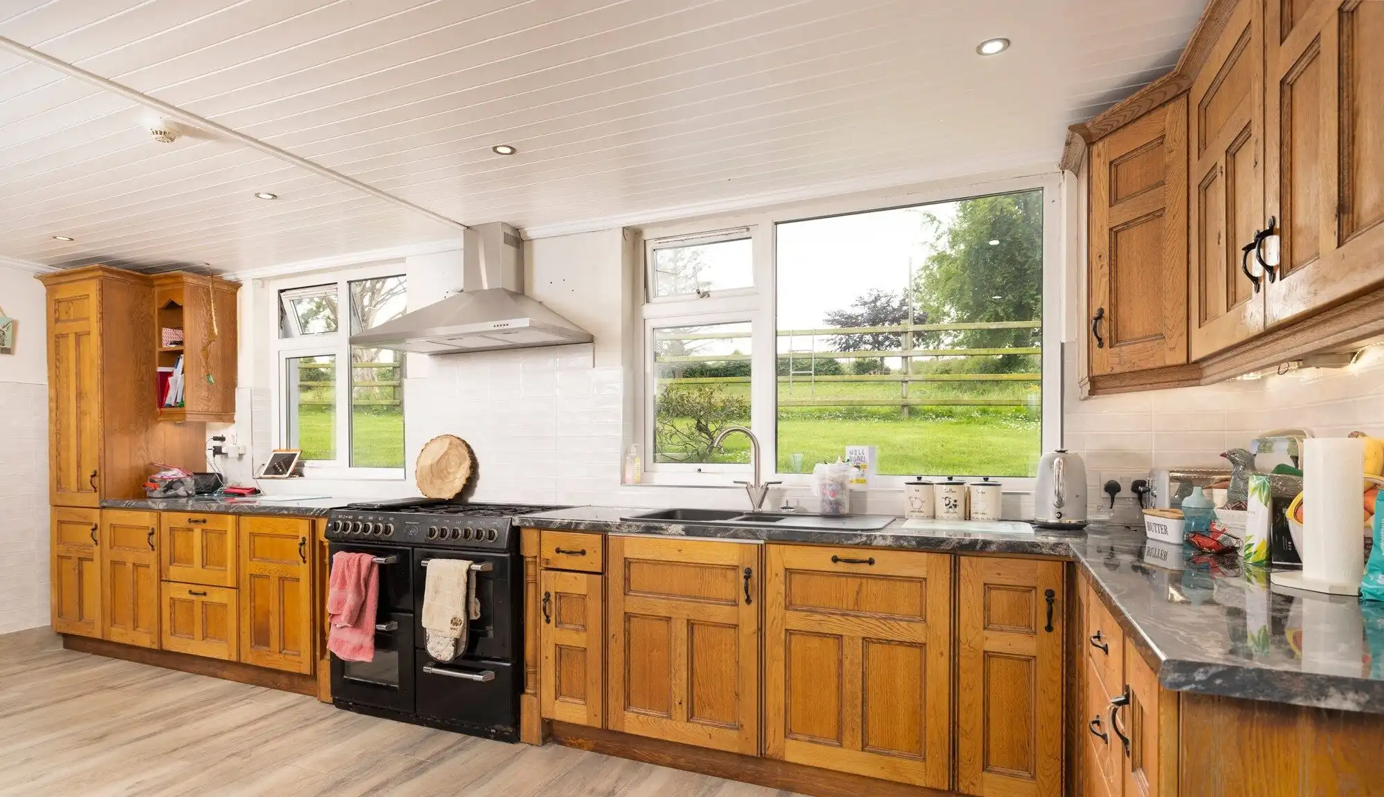Bright kitchen with wooden cabinets and modern appliances in Cosbystown Enniskillen. Perfect family.