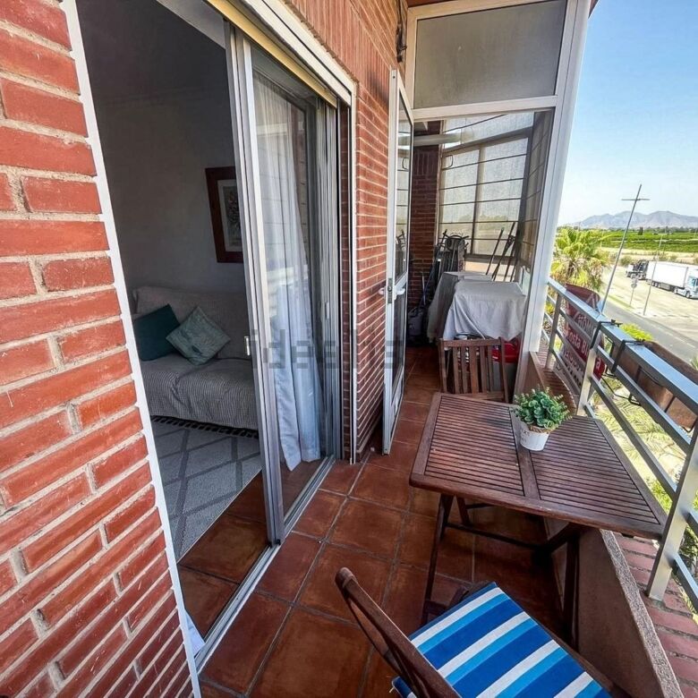 Spacious balcony of a 3-bedroom apartment in Algorfa with outdoor seating and scenic views.