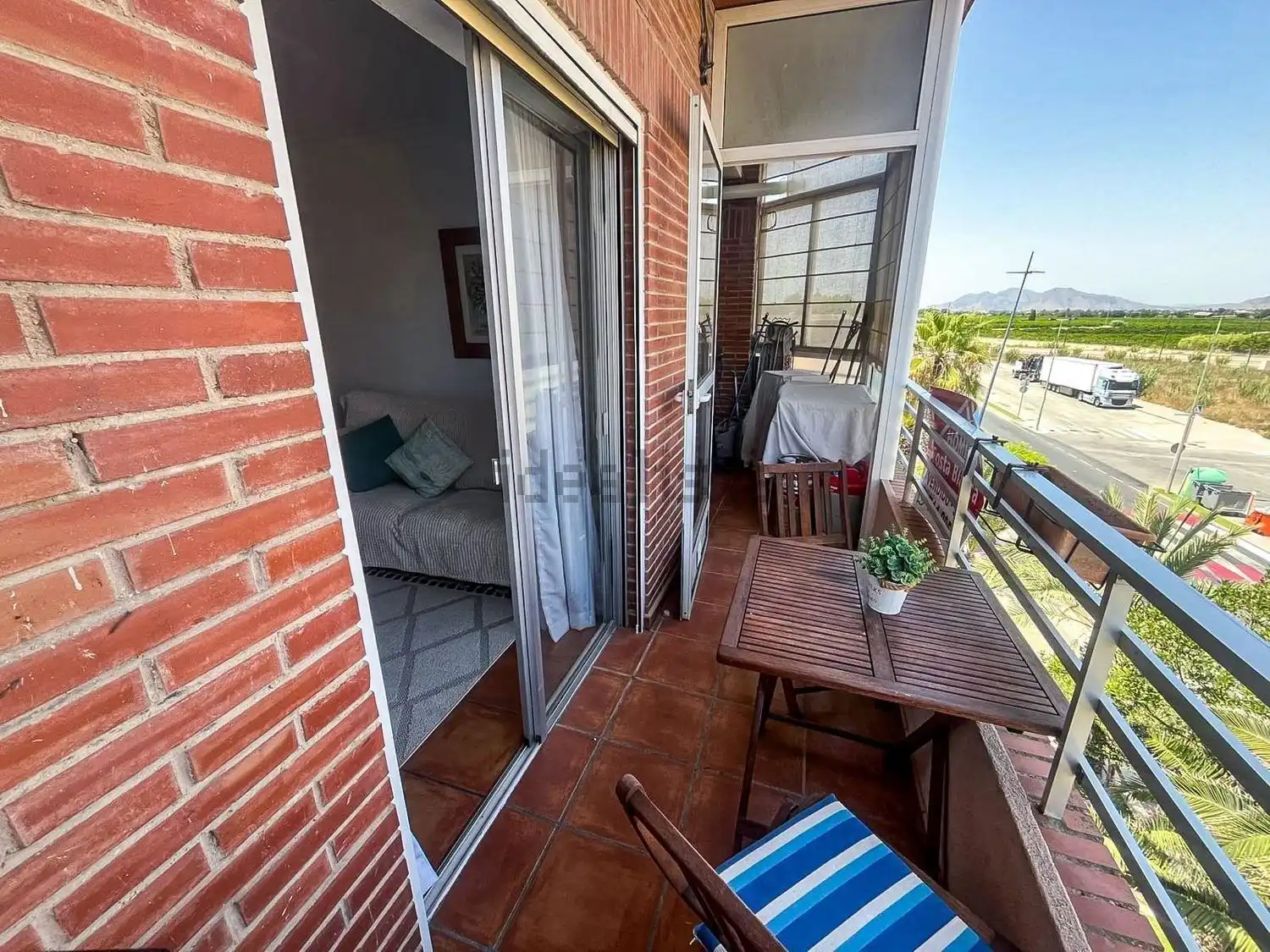 Spacious balcony of a 3-bedroom apartment in Algorfa with outdoor seating and scenic views.