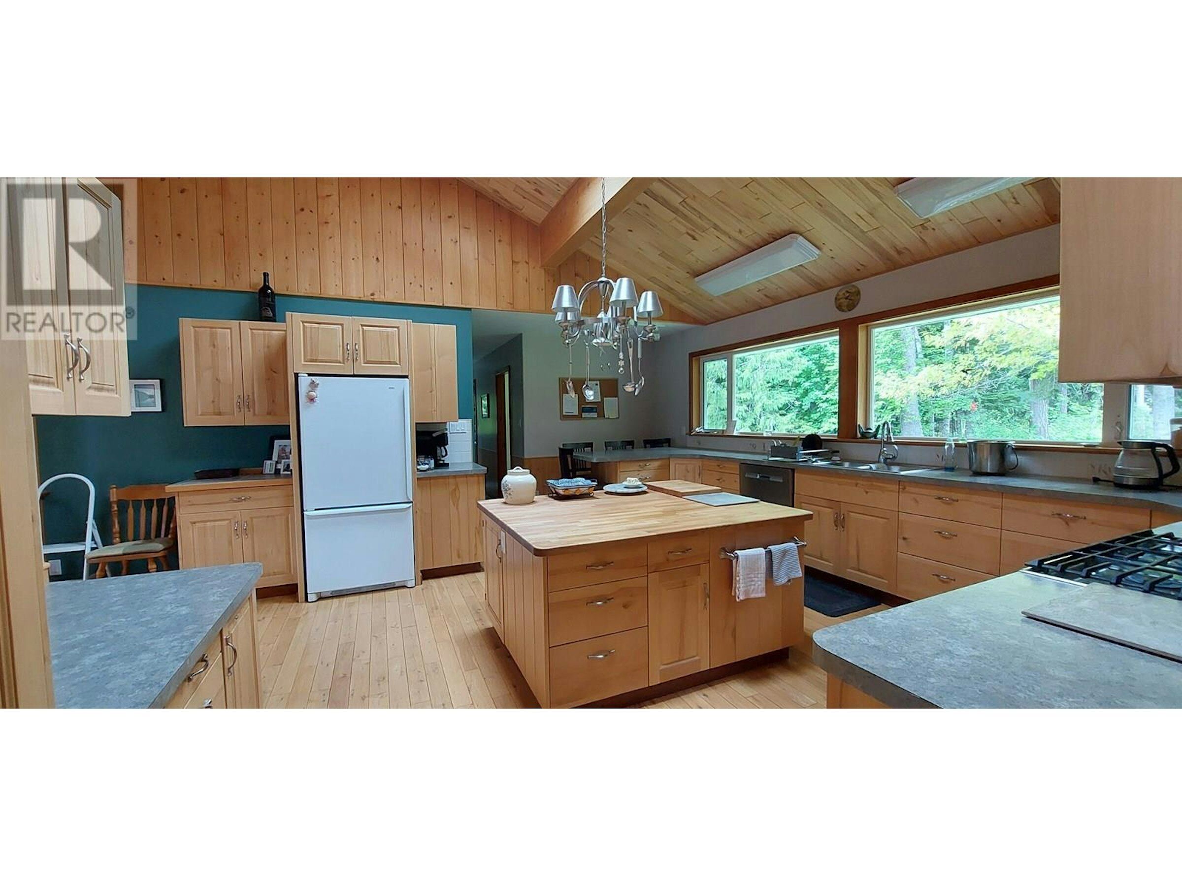 Modern Kitchen in Bella Coola Estate Beautiful kitchen with wooden cabinets and large windows in Bella Coola, British Columbia.