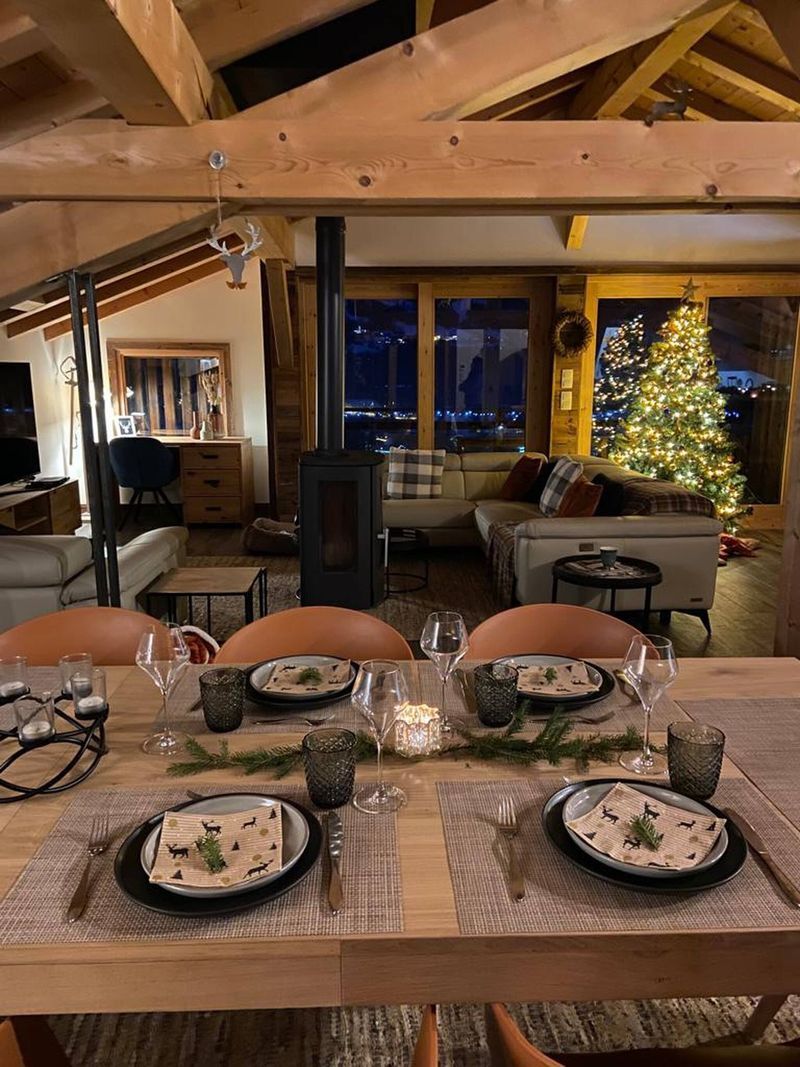 Luxury 5 Bed Chalet Interior Cozy chalet living room with Christmas tree and large windows in Samoens.