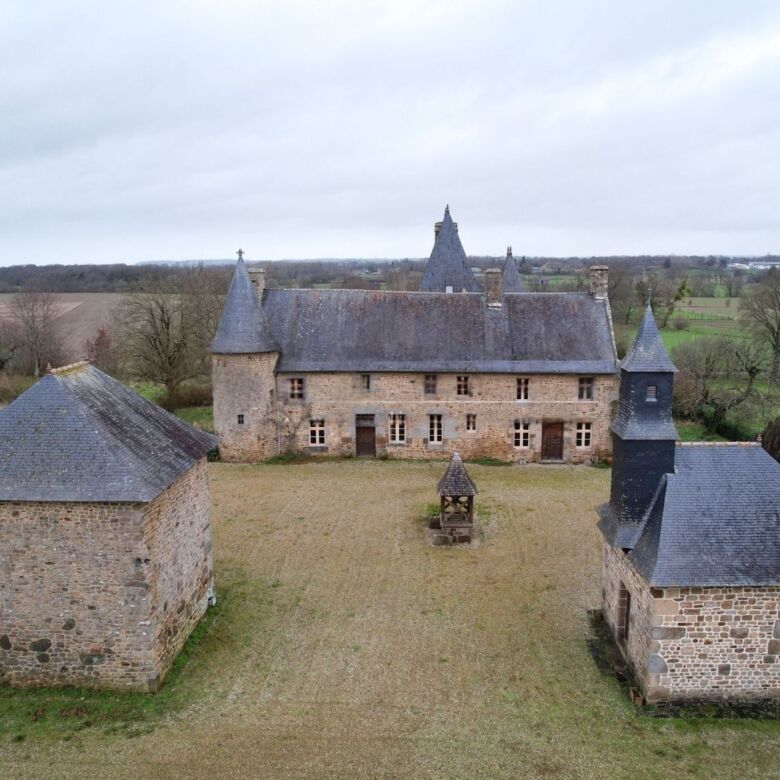 Le Manoir de Dougeru historic castle for sale in Normandy, featuring five bedrooms and scenic countr.