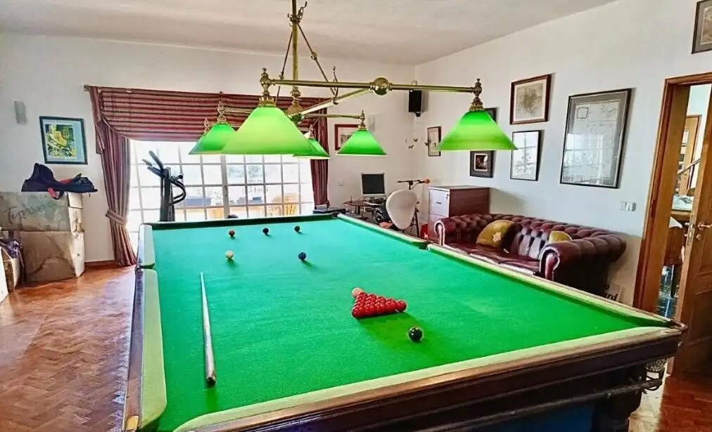 Luxury 5 Bed Country Estate & Annexe For Sale In Algoz Algarve Elegant billiard room with green felt pool table and classic decor.