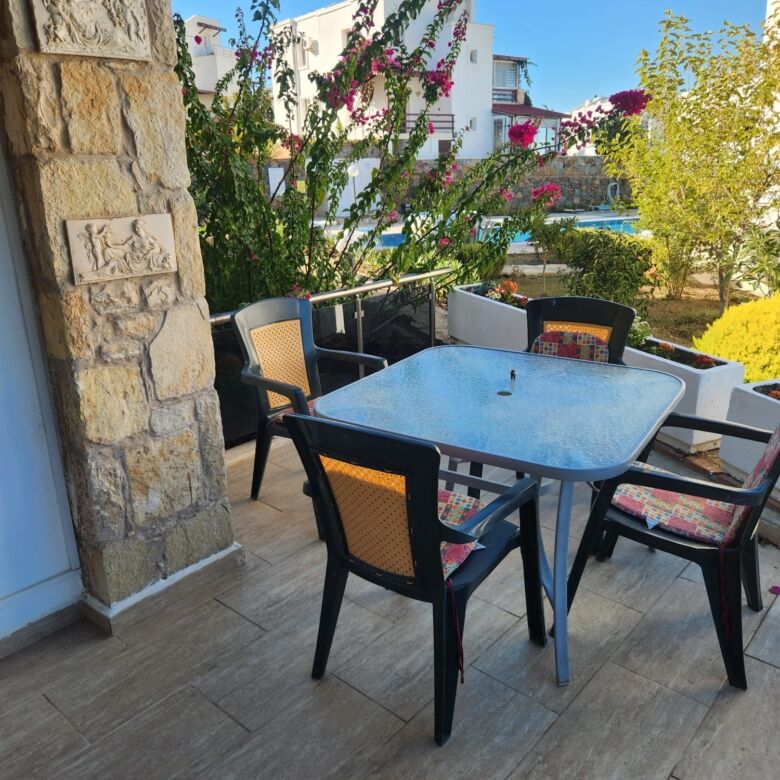 Sea view terrace with outdoor dining area in Gumusluk, Turkey. Perfect for relaxing and enjoying the.