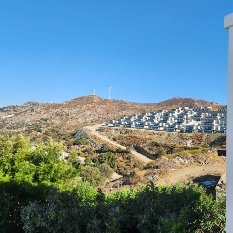 Sea view luxury 3-bedroom villa in Gumusluk, Bodrum, offering modern amenities and stunning hillside.