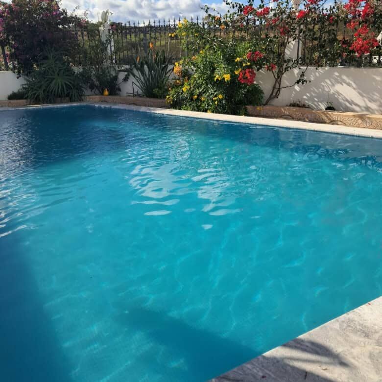 Pool view of a modern villa in Faro Algarve for sale.