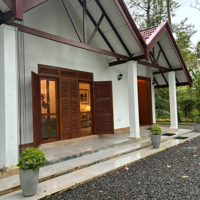 Beautiful house with wooden shutters and a spacious porch in Waikkal, Sri Lanka.